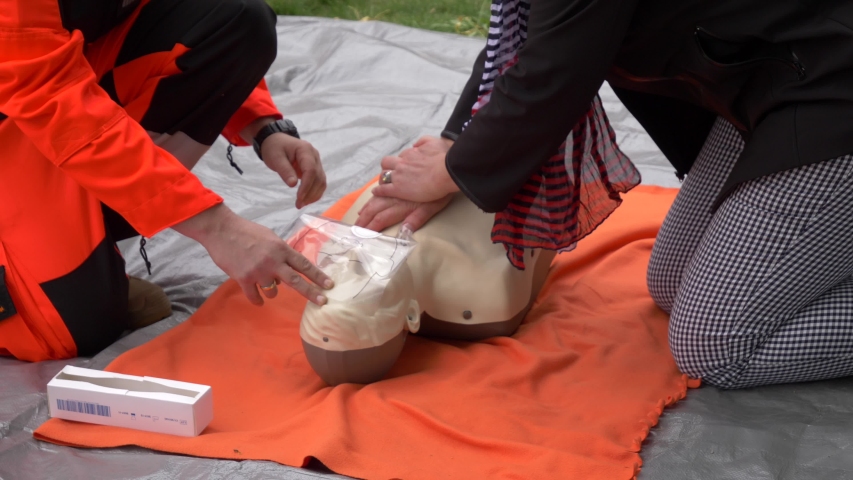 Woman trying resuscitation technique on dummy. First aid reanimation, CRP training, medicine, healthcare and medical concept Royalty-Free Stock Footage #1036391987
