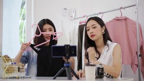 Young asian attractive woman vloggers working as fashion blogger on internet recording video for blog by cellphone at home. Female vlogger showing introducing selling online shop in live streaming.