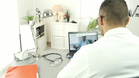 handsome doctor giving remote medical consultation with senior woman patient over internet computer telemedecine diagnostic 