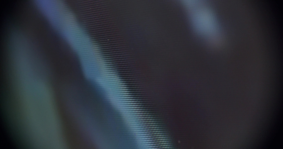 Macro shot of a screen showing moving pictures. Single Pixels visible.