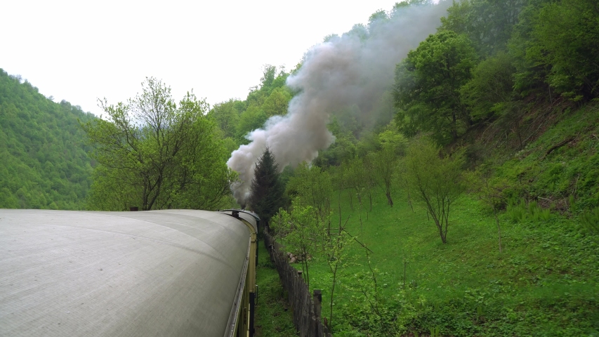 View from the roof of a retro train wagon, Old steam locomotive in Romania, Steam narrow gauge train, Steam train chugging through the countryside, narrow-gauge railwa