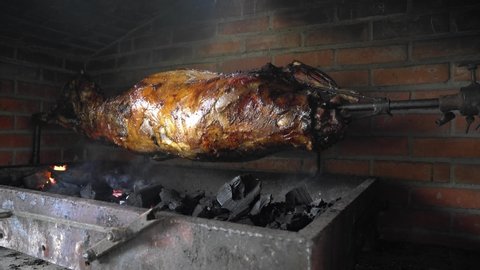 lamb carcass roasted on a spit, Sheep On Spits Roasting, Roasting whole lamb on spit