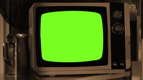 Ancient Portable TV Set Turning On and Off Green Screen. Sepia Tone. Zoom In. You can replace green screen with the footage or picture you want. You can do it with “Keying” effect in After Effects.
