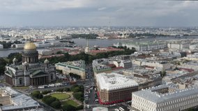 Aero video filming of St. Isaac's Cathedral and the square, panorama of the city in a sunny weather, the museum Hermitage, Palace Square, the river Neva, Peter and Paul Fortress, golden domes