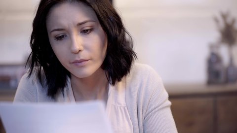 selective focus of attractive woman holding papers