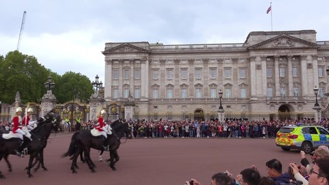 LONDON, ENGLAND - CIRCA 2018 - Buckingham palace mounted guards ride horses in front of Buckingham Palace London, England.