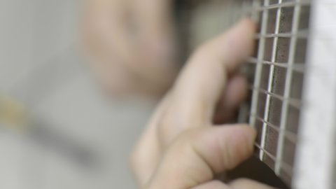 Playing guitar 4K. Close up of left hand
