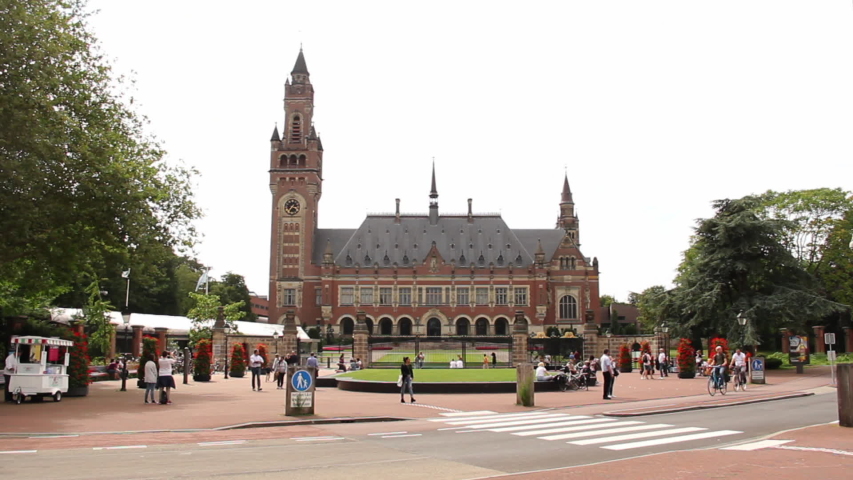 Peace Palace in the Hague with Tourists - wide overview - tilt up. It houses the International Court of Justice and is a popular tourist attraction in the Netherlands.
