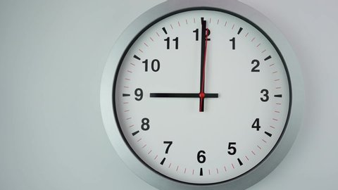 Close up Move the camera angle from left to right, Nine o'clock Start time work, Gray wall clock on  White background, Time Lapse Clock walking 60 minute.