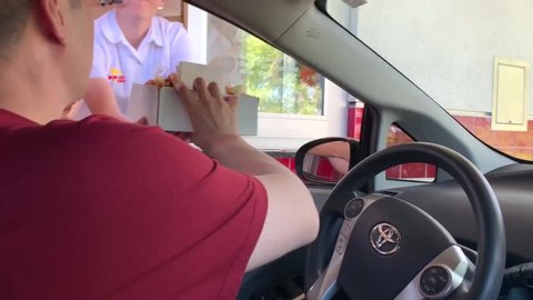 Redding , California / United States - 07 26 2019: Redding, CA (USA) - July 26, 2019. Man at the drive-thru window of a IN-N-OUT burger fast food restaurant.
