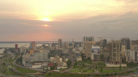 Africa, Ivory Coast, Abidjan, Sunset behind the city, drone aerial view