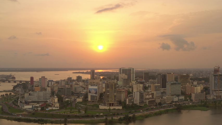 Africa, Ivory Coast, Abidjan, drone aerial view above the city center during the sunset Royalty-Free Stock Footage #1036449443