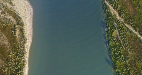 Aerial View of Danube River Mouth Flowing into the Black Sea, Sfantu Gheorghe, Romania, sunny summer day
