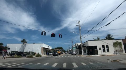 Key West, United States - 06 19 2019: Inside car dashboard view, driving on street, Key West on bright sunny day, Florida