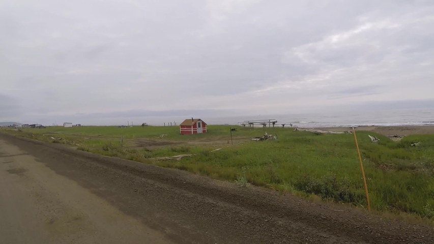 Passenger POV of native fish camps and wooden cabins. Nome - Council Highway, Alaska