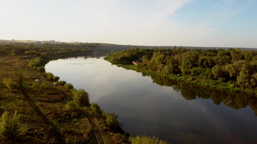 Aerial view of the long lake between the fields in sunny weather | Shutterstock HD Video #1036458998