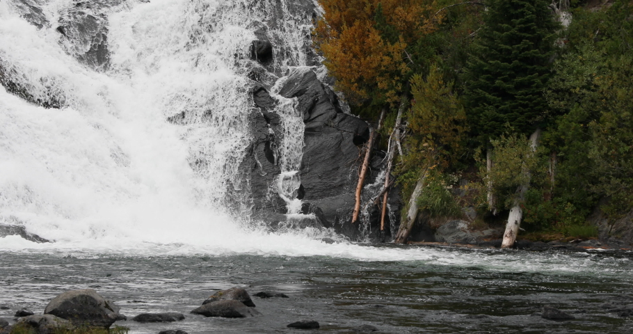 Yellowstone National Park Lewis Falls beautiful cascade. Nature, science and environment merge in ecosystem balance. Tourism and travel.