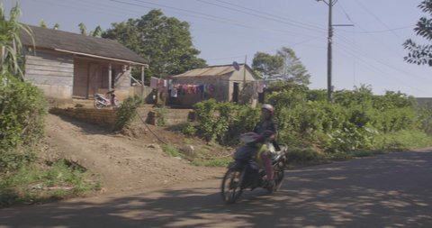 Da Lat / Vietnam - 01 01 2016: mopeds passing by a house in rural Vietnam