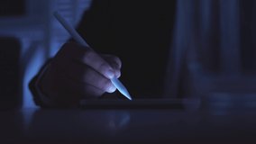 businessman hands using digital tablet with stylus pen touching on digital screen at office and nighttime.