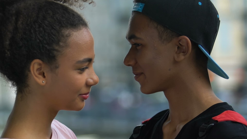 Young multiethnic couple hugging, enjoying romantic pastime together, love