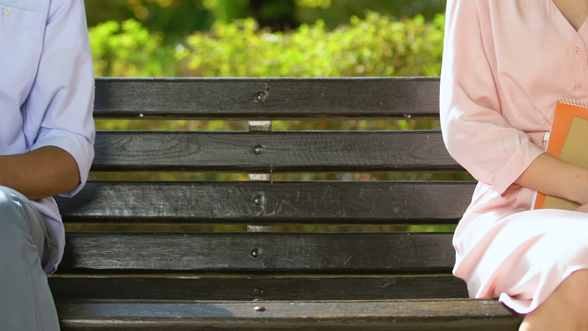 Coquette female student sitting closer to mixed-race guy in eyeglasses, flirt