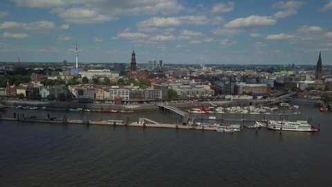 Scenic panorama over the Hamburg harbor with Landungsbruecken, the old harbor district Speicherstadt, ships and boats on river Elbe, and the TV tower with the St. Michaelis church