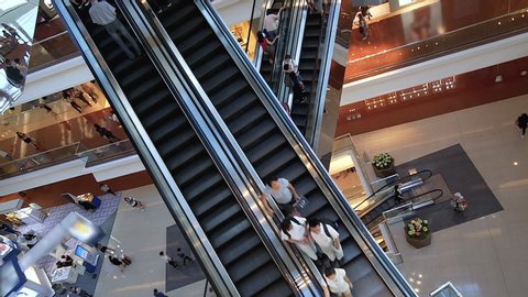 Escalators in modern shopping mall Consumption, sales. Huge modern shopping mall with many staircases. Time lapse