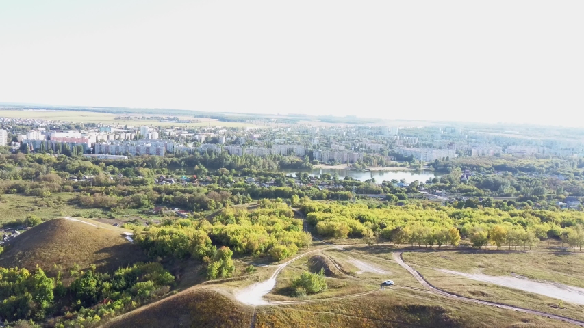 Beautiful spring and summer landscape. Mountain country road among green hills. Lush green hills, high mountains. Spring flowering grass. Summer natural background.