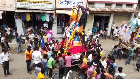 NAGPUR, MAHARASHTRA, INDIA- 31 AUGUST 2019: The crowd of unidentified people celebrating the Marbat festival to protect the city from evil spirits. The statues procession of evil forces on the street.