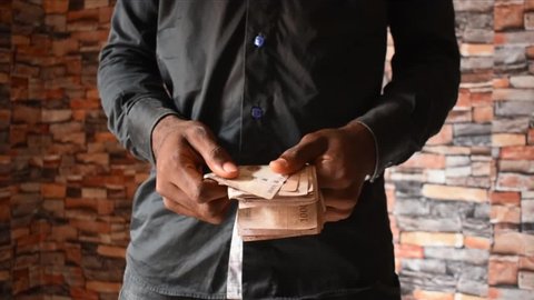 a young nigeria man counting his money