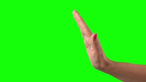 Closeup view of white woman making stop gesture first then beckoning gesture. Hand with modern stylish painted colourful nails isolated on green background. 4k video footage.