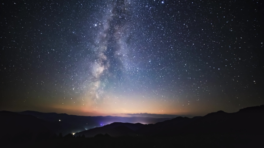 Night timelapse of moon setting behind the mountains and the Milky Way rising over the mountain range | Shutterstock HD Video #1036502078