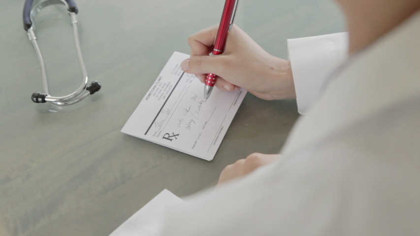 Caucasian doctor writing a prescription Royalty-Free Stock Footage #1036505999