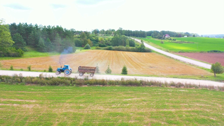 Ariel view of tractor ploughing the farmland. Ariel view tractor ploughing farmland farm farmer drone phantom agriculture machinery plough work eco economy crop

