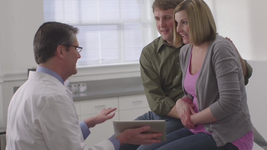 Caucasian gynecologist sharing good news with couple | Shutterstock HD Video #1036507094