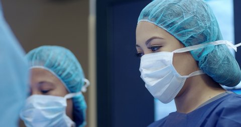 Surgeon and nurses in operating room