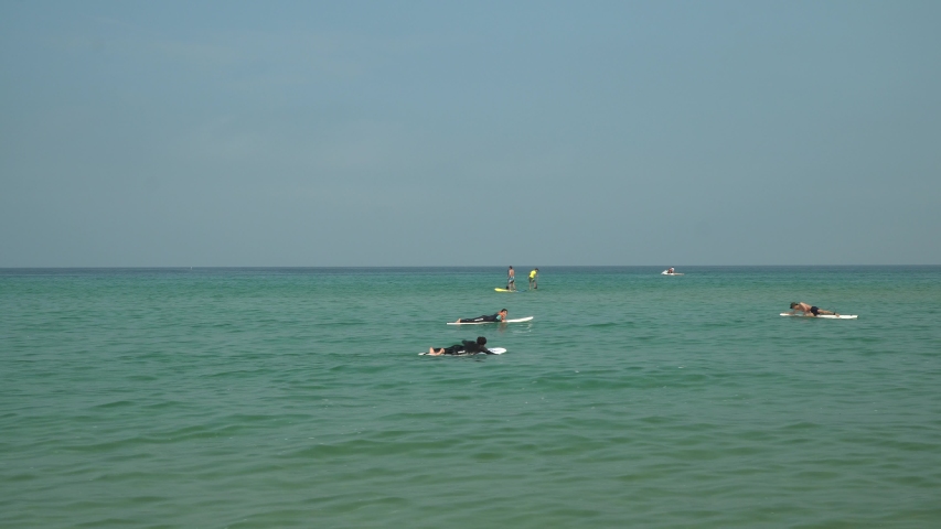 Korean people surfing on dead calm weather, studing surfing on surfyy beach in Seokcho area, Yangyang area, South Korea