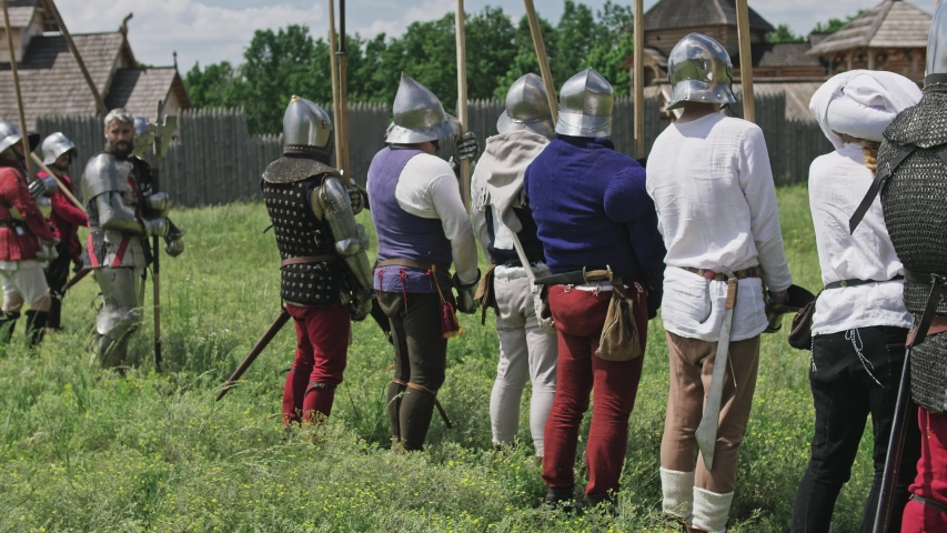 Knights in offensive. Warriors preparing to the attack and the artilleryist shoot from the cannon.