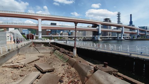 Kobe, Japan - August 12 2019: Hamate By-pass Viaduct motorway elevated bridge. Day view of freeway steel & haunched double deck girder bridge with front view of Port of Kobe Earthquake Memorial Park.