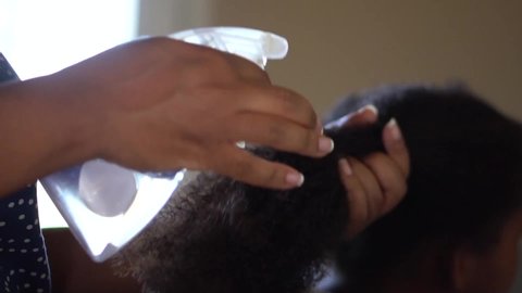 Spraying Water on Tips of Black Girls Curly Hair, Slow Motion Close Up