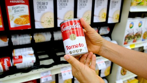 Los Angeles, CA/USA 09/4/2019
Shoppers hand holding a tin can of Campbell's condensed tomato soup for sale in supermarket aisle