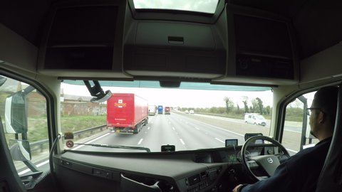 Lutterworth / United Kingdom (UK) - 03 27 2019: An in cab lorry view of a lorry driver overtaking a Royal Mail truck on the M1 motorway.