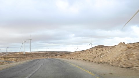 Driving on the Kings Highway (scenic route between Amman and Petra) Stunning road flanked by wind turbines, Jordan.