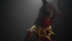 Profile shot of a demon woman with red and black skin, long horns, close up - Powered by Shutterstock - Get 15% off with code: PIKWIZARD15