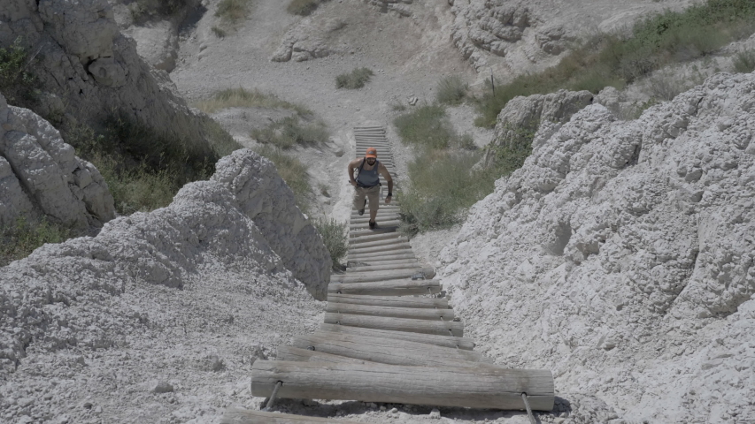Man hiking in the Badlands National Park on vacation