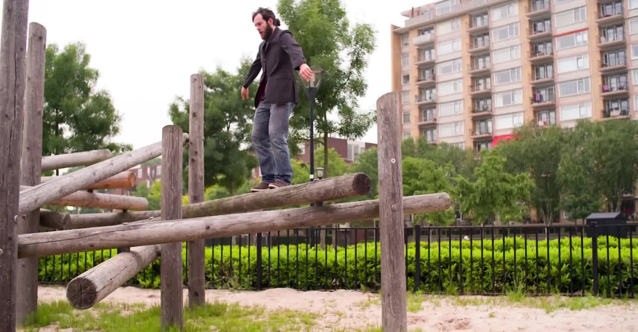 Man in suit does a backflip in super slowmotion
