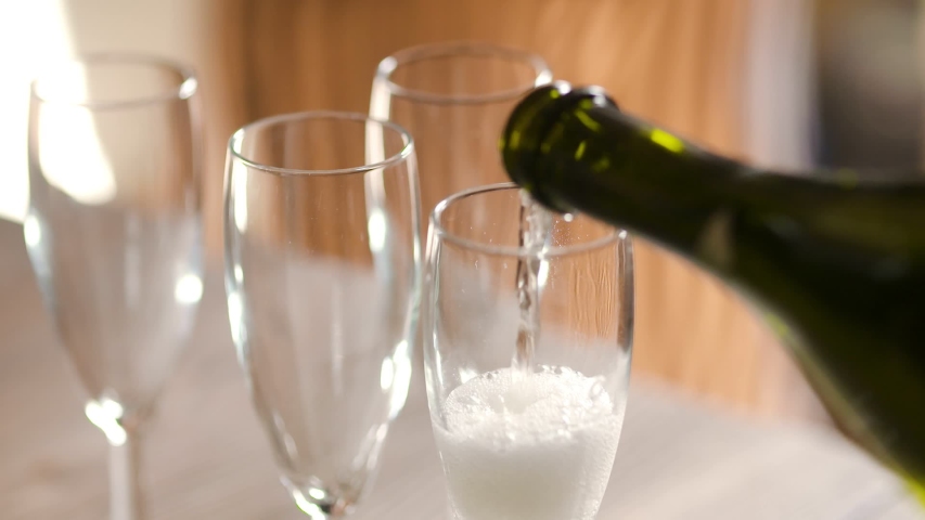 pouring champagne into glases wedding reception