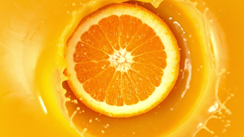 Super Slow Motion Shot of Fresh Orange Slice Splashing to Orange Juice at 1000fps. Royalty-Free Stock Footage #1036565624