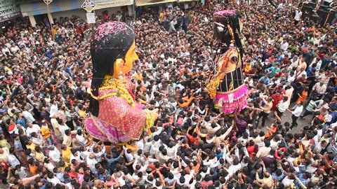NAGPUR, MAHARASHTRA, INDIA- 31 AUGUST 2019: The crowd of unidentified people celebrating the Marbat festival to protect the city from evil spirits. The statues procession of evil forces on the street.