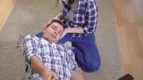 Sick man with epileptic seizures on the floor, his wife supports him, the concept of family care